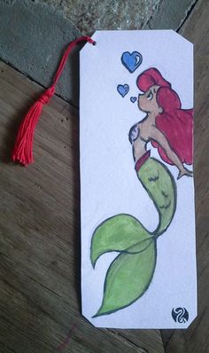 the little mermaid bookmark has been drawn with colored pencils and watercolors