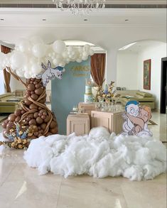 a large balloon tree in the middle of a room filled with white clouds and balloons