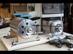 a machine that is sitting on top of a wooden table next to some other tools