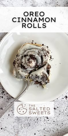 a white plate topped with a piece of cake covered in icing