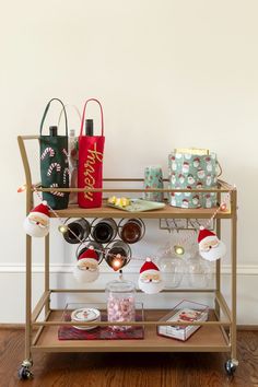 a gold bar cart filled with christmas gifts