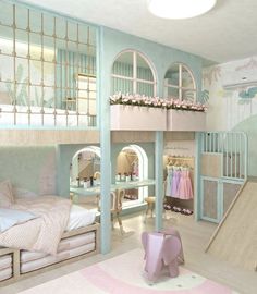 a room with bunk beds, pink and blue decor and other items on the floor