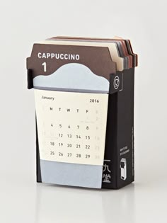 a desk calendar is stacked on top of each other in a book holder that holds several books