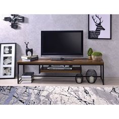 The Bob TV stand simply states that you are up with the times, with its industrial looks and the mixing of black metal with weathered oak. The thicker wood top is supported by lighter scaled black metal lags and a stretcher which assures a sturdy surface. The black powder coating on the metal tube adds to its strength and durability while providing an attractive finish. The design is sure to last for many years, it will create a perfect space in your home. Metal Tv Stand, Black Tv Stand, Solid Wood Tv Stand, Cool Tv Stands, Rack Tv, Tv Stand With Storage, Tv Stand Wood, Acme Furniture, Tv Stands And Entertainment Centers