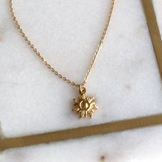 "Stylish and gorgeous our tiny sun charm necklace is perfect for everyday wear.  This is the perfect gift for a graduate, best friend, sister and even yourself!!    D E T A I L S *Dainty 10mm gold plated sun charm  *14kt Gold-Filled delicate link chain LENGTH Available in 16, 18 or 20 inches. *Model is wearing 16\" in photos HOW TO PERSONALIZE *Select your choices from the drop down menu to create your custom design. ∙ EXTRA LOVE ∙ Handcrafted just for you in sunny Arizona by a team of talented women. All of our jewelry comes gift packaged! We are happy to leave a note if this is a special gift, just let us know in the message box at checkout. PRODUCTION ∙ TIMES All items are made to order. Please check the estimated delivery in the shipping section for the most current production time. If Dainty Necklace Gold, Large Gift Boxes, Original Necklace, Sun Charm, Sun Necklace, Gold Filled Necklace, Dainty Gold Necklace, Celestial Jewelry, Large Gift