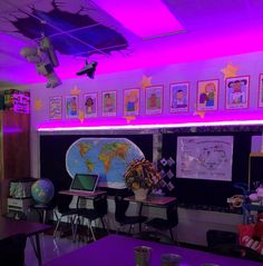 a classroom with purple lighting and pictures on the wall