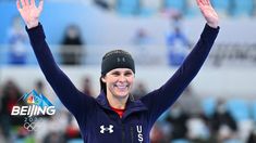 a woman is holding her hands up in the air while wearing a headband and smiling