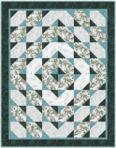 a green and white quilted wall hanging