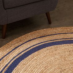 a blue and beige rug on the floor next to a couch