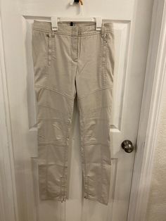 Elevate your wardrobe with these vintage BCBGMAXAZRIA women's cargo pants in a chic beige color. Perfect for any occasion, these pants feature a solid pattern, button closure, and flared leg style. They are made from high-quality leather material and have a low rise, making them comfortable and stylish.  These pants are perfect for travel, weddings, parties, casual, formal, workwear, and business attire. With a size of M and a waist size of 30 in, they are suitable for any body type. These pants Cargo Pants Women, Pants Design, Business Attire, Asymmetrical Design, Beige Color, High Quality Leather, Cargo Pants, Trousers Women, Work Wear