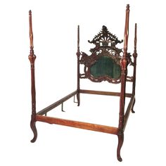 an ornate wooden bed frame with green glass in the center and two posts on each side