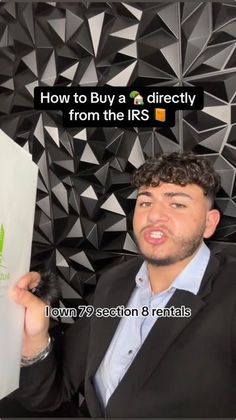 a man holding up a piece of paper with the words how to buy a directly from the irs