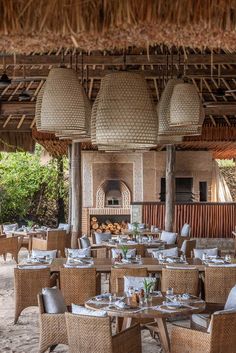 an outdoor dining area with wicker chairs and tables