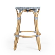 the backless stool is made from rattan and wicker, with a blue seat pad