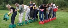 a group of people standing on top of green blocks