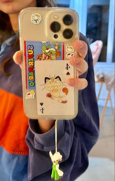 iPhone 13 with a clear case with a hello kitty, pokemon, and super Mario collage/ stickers in the case with a Luigi phone charm Iphone 12 Pro Aesthetic Case, Nintencore Aesthetic, Cool Phone Cases Aesthetic, Personalized Electronics, Super Mario Aesthetic, Iphone Aesthetic Case, Hello Kitty Pokemon, Phone Charm Aesthetic, Mario Aesthetic