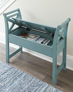 a blue wooden bench with magazines on it