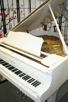 a white piano sitting in front of a wall