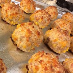 cheesy biscuits on a baking sheet ready for the oven to be baked in