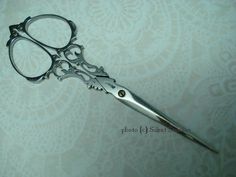 a pair of scissors sitting on top of a table