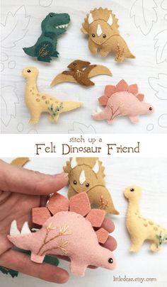 felt dinosaurs are being held by someone's hand