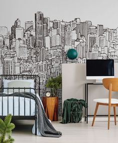 a bedroom with black and white cityscape painted on the wall next to a bed