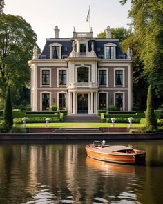 a boat floating on top of a lake next to a large building