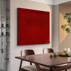 a dining room table with chairs and a large red painting on the wall