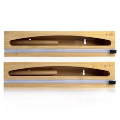 two wooden knives with black handles on each one and the other end cut out in half