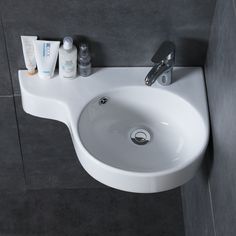 a bathroom sink with soap, toothpaste and lotion