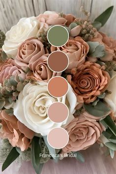 a bridal bouquet with roses and greenery in shades of pink, peach, green