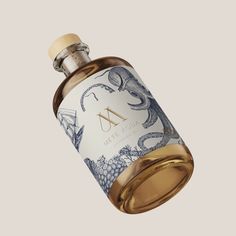 a bottle of perfume with an octopus on the top and letter a in the bottom