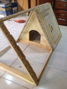 a chicken coop is sitting on the floor