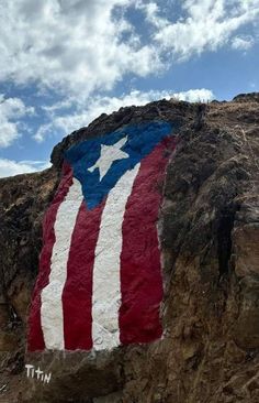 a large rock with a flag painted on it