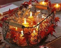 a basket filled with candles sitting on top of a table