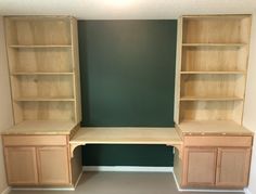 an empty room with built in bookshelves and cabinets