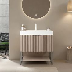 a bathroom with a round mirror above the sink