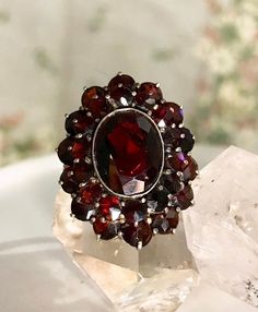 "A mesmerizing double halo Victorian bohemian garnet ring set in 14K gold. Full two rows of rose cut garnet that sparkles in unusual way. The center faceted garnet is outstandingly deep wine red. For its age, the condition is  pristine and well cared for. The garnets are identified as pyrope garnet and are all natural. This bohemian garnet ring is absolutely exceptional and one of the top quality pieces I've had the pleasure to vouch for. This ring will make a sentimental and unique engagement r Pyrope Garnet, Seed Pearl Ring, Amethyst Ring Engagement, Gold Statement Ring, Etsy Gold Ring, Blue Sapphire Diamond, Garnet Jewelry, 14k Rose Gold Ring, Double Halo