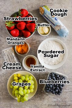 the ingredients to make an ice cream sundae are shown in bowls, including grapes, strawberries, blueberries, and butter