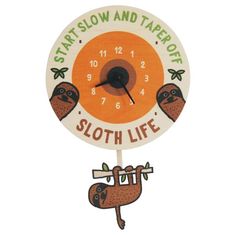 an orange and white clock with three slots hanging from it's sides, says start slow and tarrorr sloth life