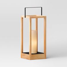 a wooden lantern with a white candle inside