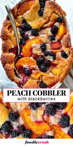 a peach cobbler with blackberrys and blueberries is shown in the foreground