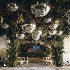 disco balls hanging from the ceiling in an indoor venue