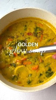 a hand holding a ladle in a bowl of soup with the words golden glow soap on it