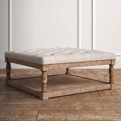 a white bench sitting on top of a wooden floor