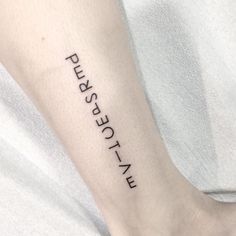 a person with a small tattoo on their arm that says, push rest sit up