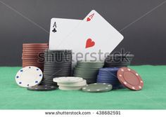 poker chips and playing cards on green tablecloth with copy space for text or image