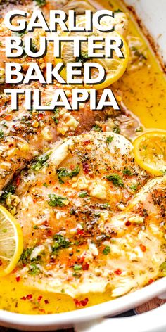 garlic butter baked tilapia in a white dish with lemons and parsley