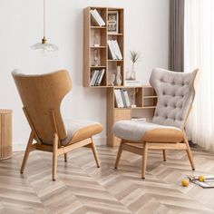 a living room with two chairs and a book shelf