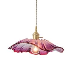 a pink flower hanging from a light fixture